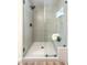 Bathroom glass shower with a built in bench, tiled walls and floor at 10205 Birch Bluff Ln, Las Vegas, NV 89145