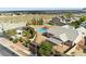This aerial view highlights an inviting backyard with a pool, covered patio, desert landscaping, and mountain views at 10302 Artful Stone Ave, Las Vegas, NV 89149