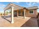 Inviting covered patio perfect for outdoor dining and entertaining with a lattice overhead at 10302 Artful Stone Ave, Las Vegas, NV 89149