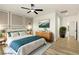 Comfortable bedroom with a large bed, stylish decor, a ceiling fan, and hardwood flooring at 10302 Artful Stone Ave, Las Vegas, NV 89149