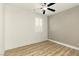 Bright, airy bedroom with ample natural light and wood-look flooring at 10302 Artful Stone Ave, Las Vegas, NV 89149