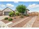 Charming single-story home featuring a well-maintained front yard with desert landscaping and a two-car garage at 10302 Artful Stone Ave, Las Vegas, NV 89149