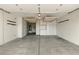 Spacious garage featuring ample storage with custom cabinets and overhead racks for organization at 10302 Artful Stone Ave, Las Vegas, NV 89149