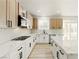 Bright kitchen features stainless steel appliances, two-tone cabinets and a large island with a breakfast bar at 10302 Artful Stone Ave, Las Vegas, NV 89149