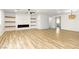 Bright open living room with decorative fireplace, wood floors, recessed lighting, and a modern ceiling fan at 10302 Artful Stone Ave, Las Vegas, NV 89149