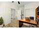 Well-lit office space featuring a desk, chair, and built-in shelving with neutral paint and luxury vinyl plank flooring at 10302 Artful Stone Ave, Las Vegas, NV 89149