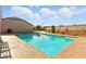 Refreshing backyard pool perfect for summer fun, with a large patio and lush landscaping at 10302 Artful Stone Ave, Las Vegas, NV 89149