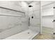 Stylish walk-in shower with marble-look tile, black fixtures, and a convenient shower niche at 10302 Artful Stone Ave, Las Vegas, NV 89149