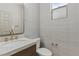 Stylish powder room with wallpaper, stone countertop, gold fixtures, and modern toilet at 10368 Mystic Pine Rd, Las Vegas, NV 89135