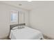 Simple bedroom with white walls, wood floors, and window with blinds at 10368 Mystic Pine Rd, Las Vegas, NV 89135