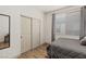 Comfortable bedroom showcasing a window, wood-look floors, closet, and mirror at 10368 Mystic Pine Rd, Las Vegas, NV 89135
