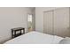 Bright bedroom featuring a closet, bedside table, neutral walls, and light wood-look flooring at 10368 Mystic Pine Rd, Las Vegas, NV 89135