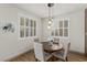 Cozy dining area with round table, pendant lighting, and bright windows featuring stylish plantation shutters at 10368 Mystic Pine Rd, Las Vegas, NV 89135