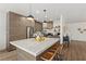 Spacious kitchen with large marble island, stainless steel appliances, and ample wood cabinets at 10368 Mystic Pine Rd, Las Vegas, NV 89135