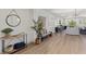 Bright living room features wood floors, light gray sofas, neutral decor, and large windows with plantation shutters at 10368 Mystic Pine Rd, Las Vegas, NV 89135