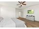 Main bedroom with ceiling fan, wood floors, and bright natural light at 10368 Mystic Pine Rd, Las Vegas, NV 89135