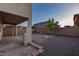 Backyard featuring rock landscaping, a brick patio, and a tree surrounded by decorative bricks at 1037 Water Cove St, Henderson, NV 89011