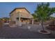 A backyard with gravel landscaping, a small tree, and a covered patio connected to the house at 1037 Water Cove St, Henderson, NV 89011