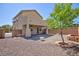 Backyard view showcasing the desert landscaping, covered patio, brick accents and plenty of space for outdoor enjoyment at 1037 Water Cove St, Henderson, NV 89011
