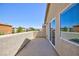 A spacious stucco balcony with mountain views and sliding glass doors under a clear blue sky at 1037 Water Cove St, Henderson, NV 89011