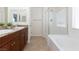 Bathroom features double vanity sinks with granite countertop, soaking tub and glass-enclosed shower at 1037 Water Cove St, Henderson, NV 89011