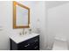 Elegant powder room featuring a navy vanity, gold hardware, quartz countertop, and a stylish gold-framed mirror at 1037 Water Cove St, Henderson, NV 89011