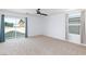 Bright bedroom with large windows, ceiling fan, plush carpet and sliding glass door access to balcony at 1037 Water Cove St, Henderson, NV 89011