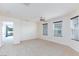 Spacious bedroom with plush carpet, ceiling fan, and large windows that provide plenty of natural light at 1037 Water Cove St, Henderson, NV 89011