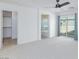 This open bedroom includes a ceiling fan, walk-in closet, and a view of the connected bathroom and bathtub at 1037 Water Cove St, Henderson, NV 89011