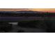 City skyline at twilight with mountains in background from a green space with bushes at 1037 Water Cove St, Henderson, NV 89011