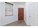 Bright entryway featuring a wooden door, wood laminate floors, and fresh paint at 1037 Water Cove St, Henderson, NV 89011
