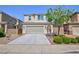 Inviting two-story home featuring a spacious driveway and desert landscaping at 1037 Water Cove St, Henderson, NV 89011
