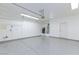 Spacious three car garage with epoxy floors, storage racks, and water heater at 1037 Water Cove St, Henderson, NV 89011