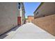 Wide side yard featuring privacy wall, access gate and concrete patio at 1037 Water Cove St, Henderson, NV 89011