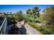 Backyard view featuring a stone fountain feature, pool, lush landscaping, and a golf course in the background at 105 Chateau Whistler Ct, Las Vegas, NV 89148