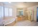 Light and bright bathroom with tiled flooring, walk-in shower, soaking tub and plantation shutters at 105 Chateau Whistler Ct, Las Vegas, NV 89148