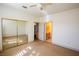 Bright bedroom with mirrored closet doors and an open doorway to an adjacent room with a bathroom at 105 Chateau Whistler Ct, Las Vegas, NV 89148
