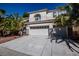 Two-story home featuring a three-car garage, a tile roof, and well-maintained landscaping with tall palm trees at 105 Chateau Whistler Ct, Las Vegas, NV 89148