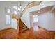 Bright entryway featuring staircase, high ceilings, shuttered windows, and earth-toned tile flooring at 105 Chateau Whistler Ct, Las Vegas, NV 89148
