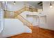 Bright two-story foyer with wooden staircase and terra cotta tile flooring at 105 Chateau Whistler Ct, Las Vegas, NV 89148