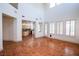 Spacious living room with high ceilings, terra cotta tile flooring, and an abundance of natural light at 105 Chateau Whistler Ct, Las Vegas, NV 89148