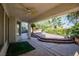 Covered patio featuring outdoor ceiling fan and view of a rock garden and lush landscaping at 105 Chateau Whistler Ct, Las Vegas, NV 89148