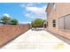 View of concrete patio with brick wall and partial home view on a sunny day at 1063 Silver Star St, Henderson, NV 89002