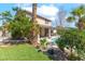 Inviting backyard area with pool, covered patio, and lush tropical landscaping at 1063 Silver Star St, Henderson, NV 89002