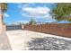Enclosed backyard with paver patio, brick wall, and mature trees at 1063 Silver Star St, Henderson, NV 89002