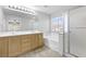 Bathroom featuring double vanity, soaking tub, and glass shower at 1063 Silver Star St, Henderson, NV 89002