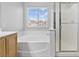 Bathroom featuring bathtub and glass enclosed shower with a window at 1063 Silver Star St, Henderson, NV 89002