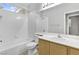 Bright bathroom showcasing a wide mirror above a vanity with one sink, with a tub and shower combination at 1063 Silver Star St, Henderson, NV 89002
