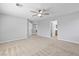 Large carpeted bedroom with a ceiling fan and multiple doorways at 1063 Silver Star St, Henderson, NV 89002