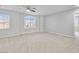 Bright bedroom with neutral-colored walls, carpet, and view out of the window offers a serene retreat at 1063 Silver Star St, Henderson, NV 89002